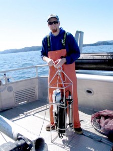 Gulf Watch scientist Rob Campbell prepares a CTD instrument for oceanographic sampling in Prince William Sound.