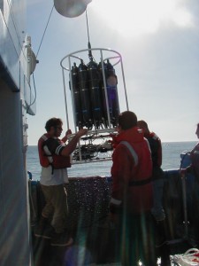 Deployment of the CTD instrument to collect salinity and temperature data continuously along its vertical descent to the ocean floor, 263 m below the vessel.