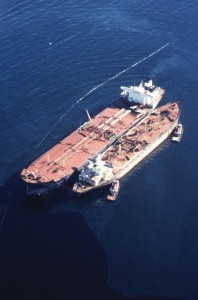 Photo of Exxon Valdez oil tanker grounded on Bligh Reef and leaking oil, March 1989.